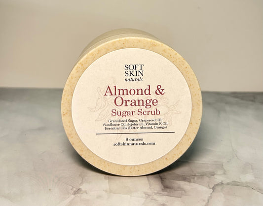 Jar of Almond & Orange Sugar Scrub by Soft Skin Naturals on a marble surface.