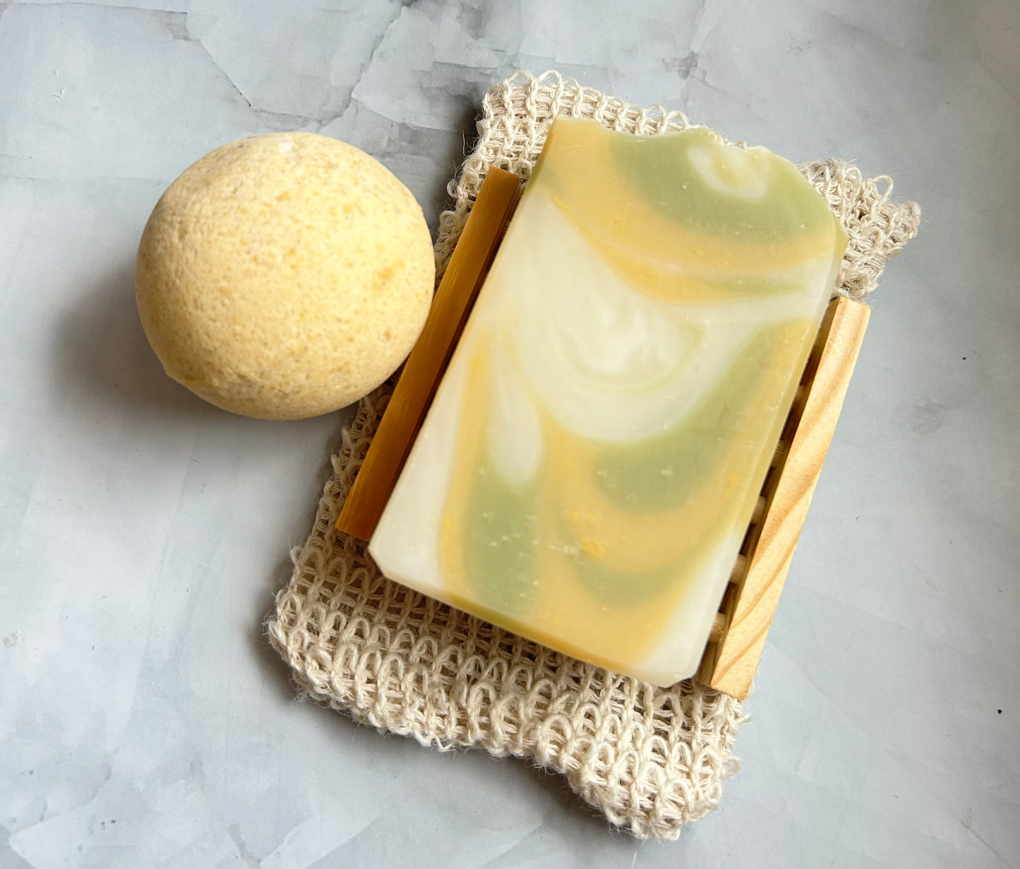 Bar of soap and bath bomb on a textured surface