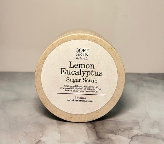 Round container of Lemon Eucalyptus Sugar Scrub with 'Soft Skin Naturals' label on a neutral background