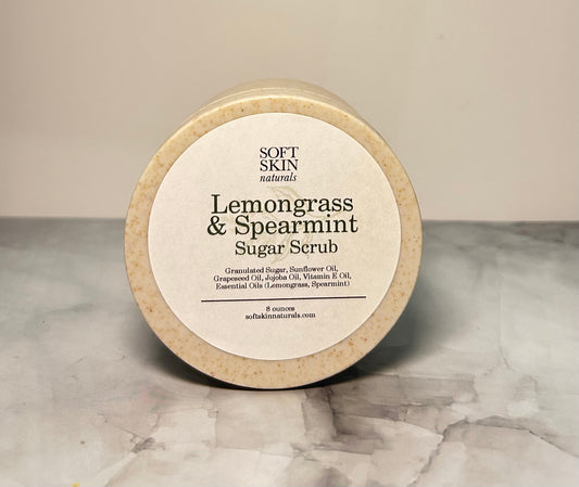 Jar of Lemongrass & Spearmint Sugar Scrub by Soft Skin Naturals on a marble surface.
