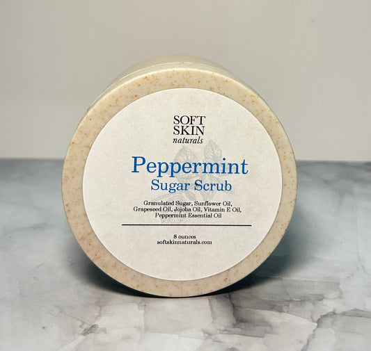 Jar of Soft Skin Naturals Peppermint Sugar Scrub on a marble surface