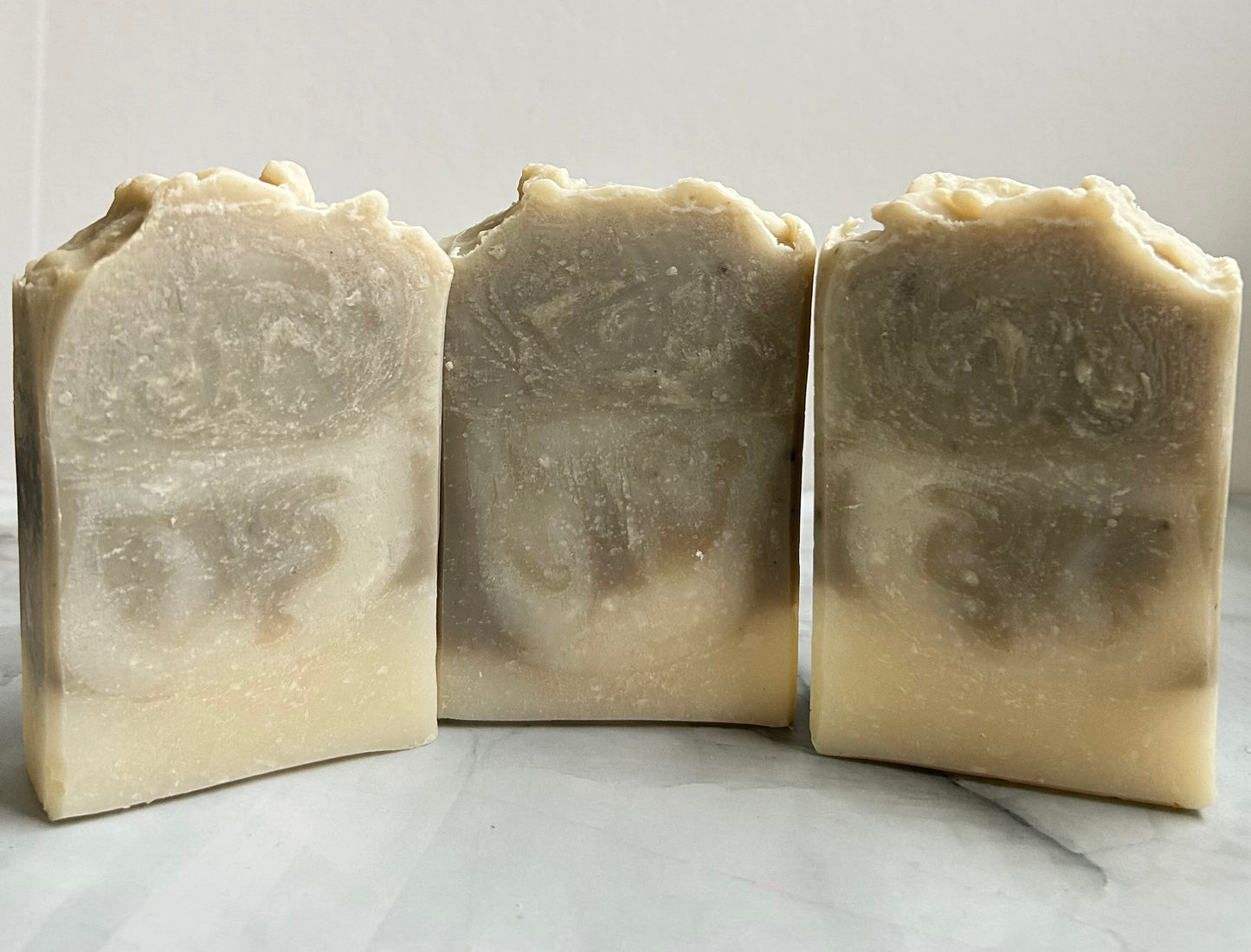 Three bars of handmade soap on a white background