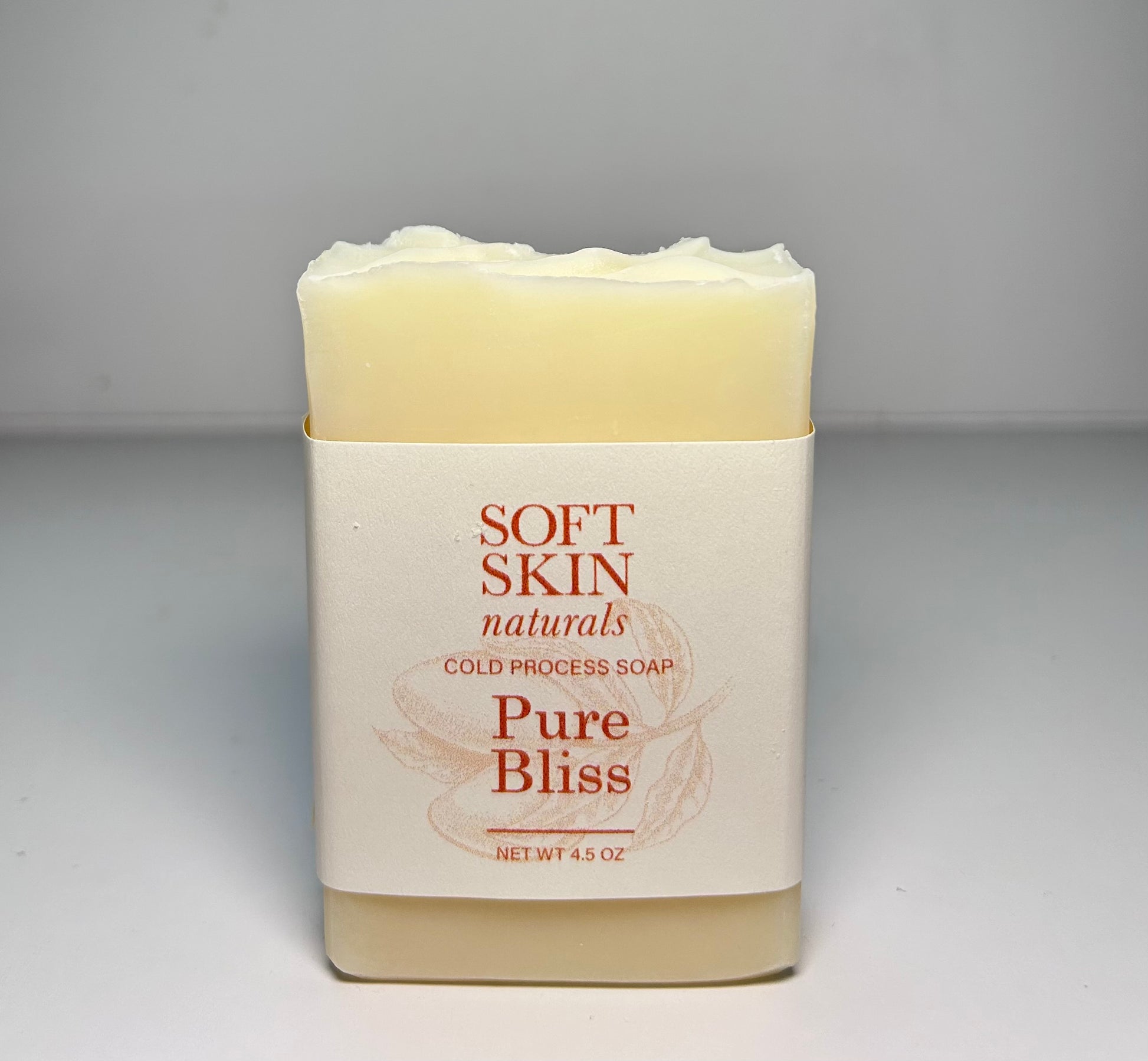 Bar of soap with Soft Skin Naturals label on a gray background