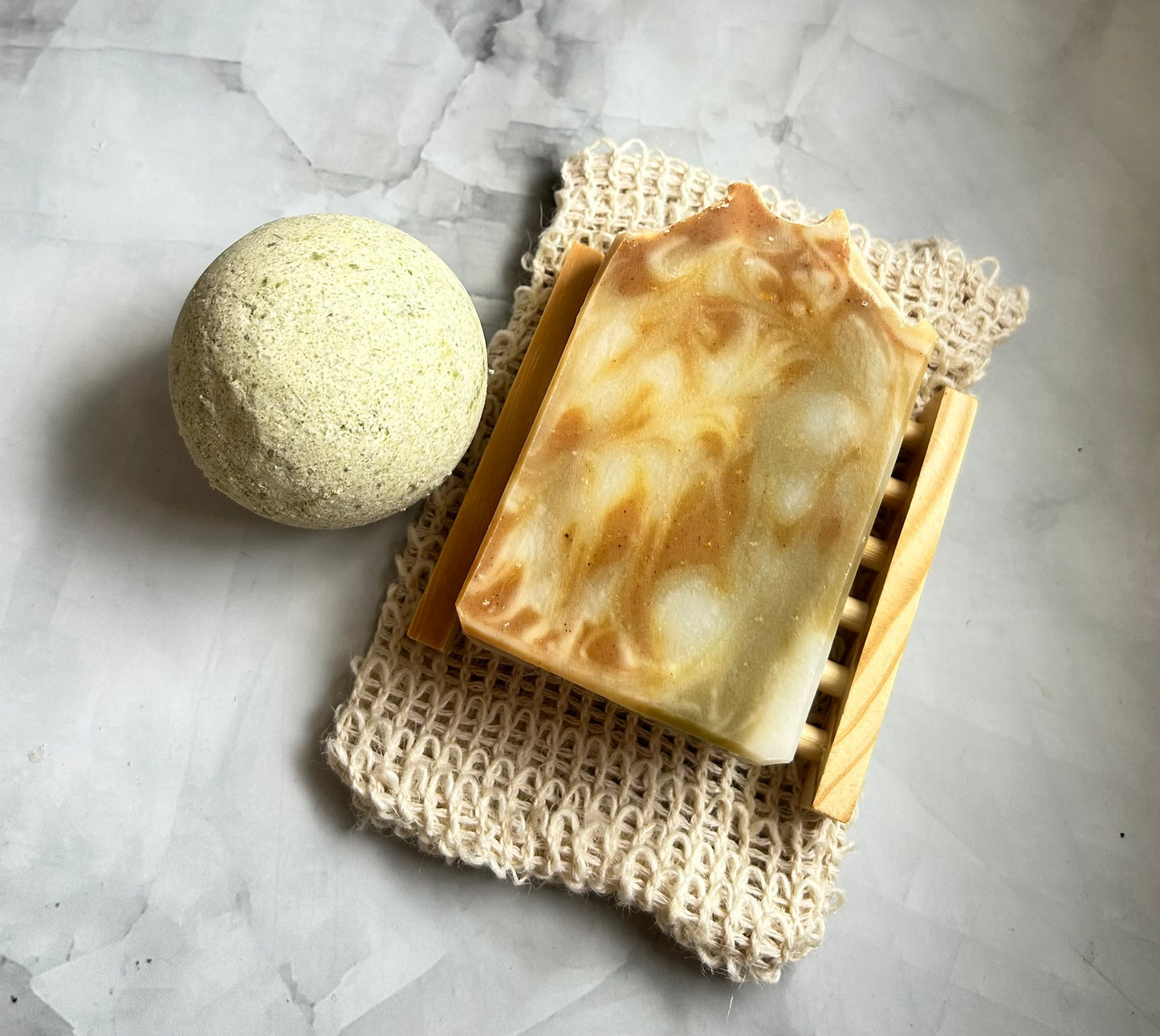 Bar of soap and bath bomb on a textured surface
