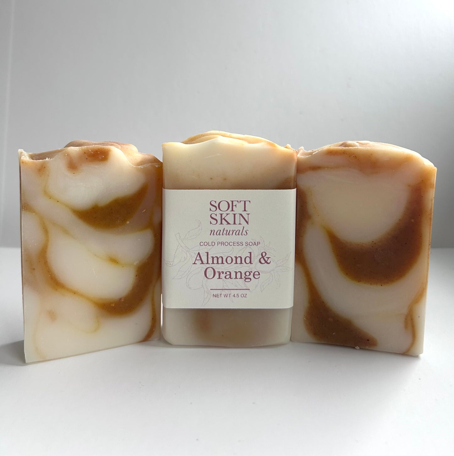 Bar of soap with almond and orange scent on a white background