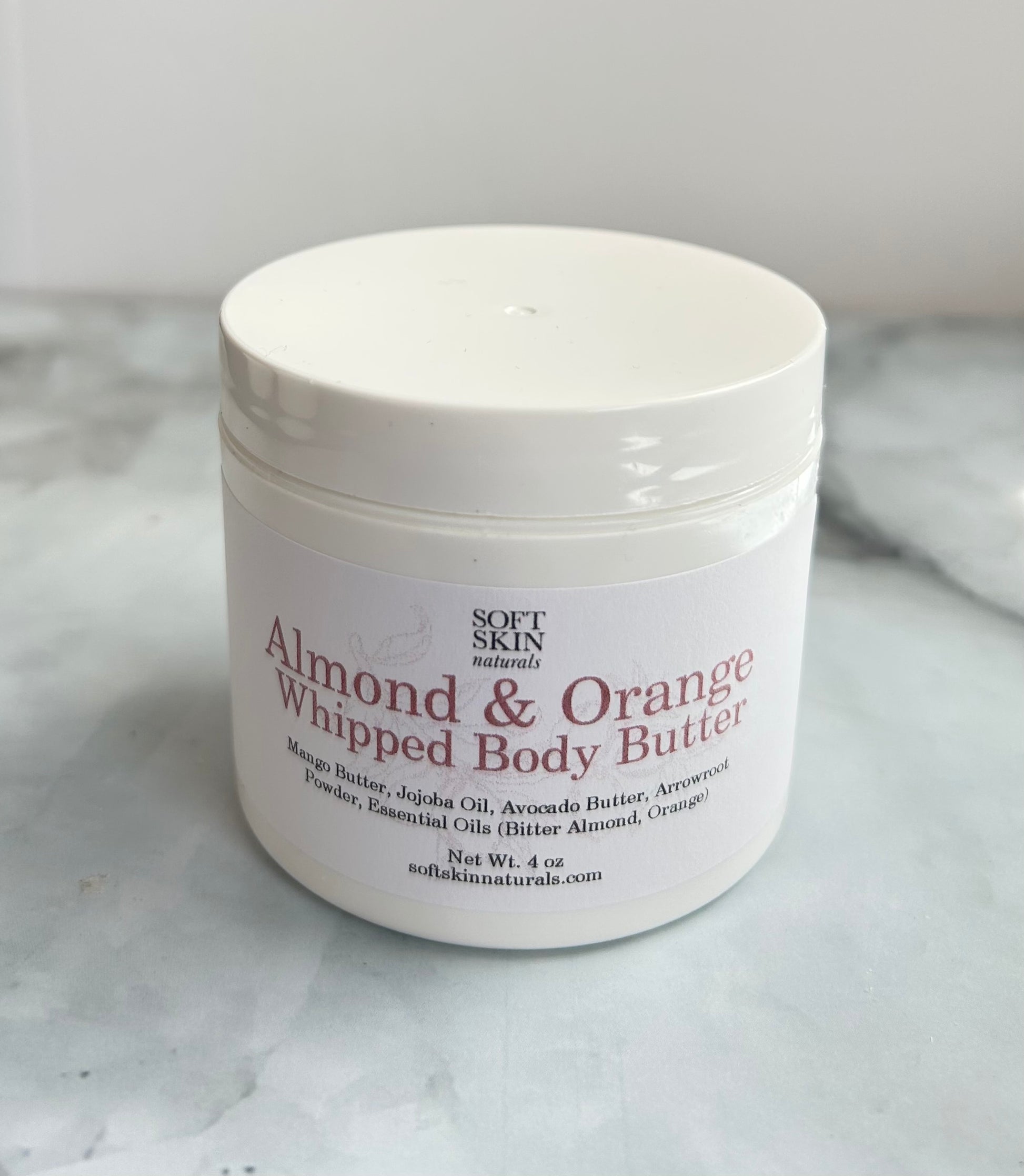 Jar of Almond & Orange Whipped Body Butter on a marble surface