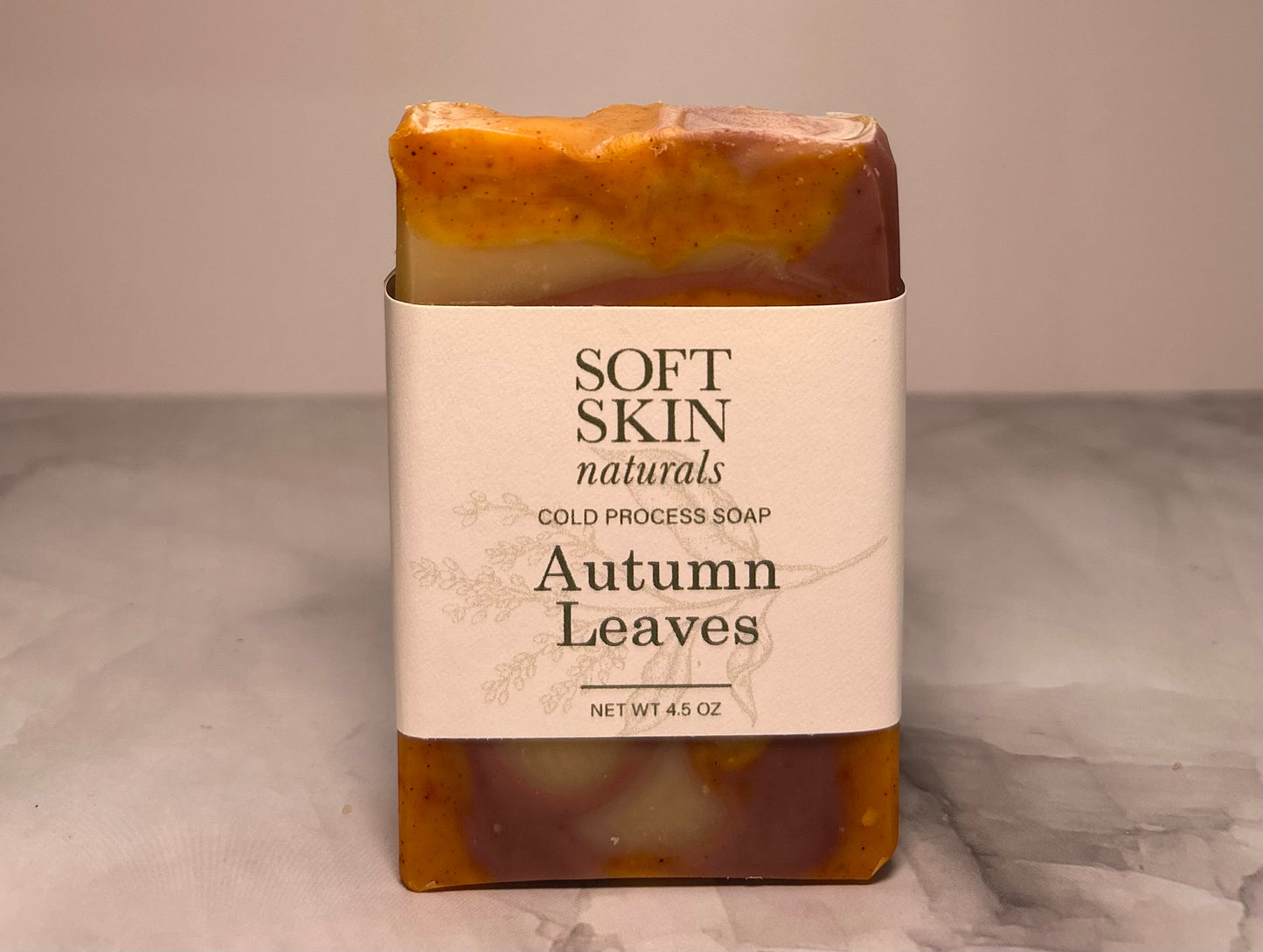 Bar of soap with 'Soft Skin Naturals' label on a neutral background