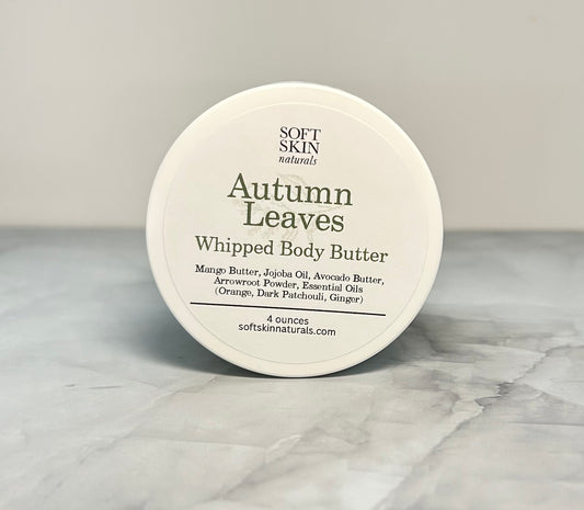 Jar of Autumn Leaves whipped body butter sitting on a table. 