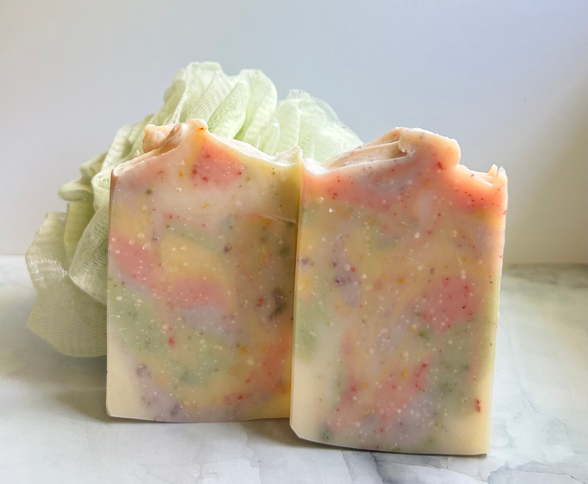 Two multi-colored soaps next to each other.