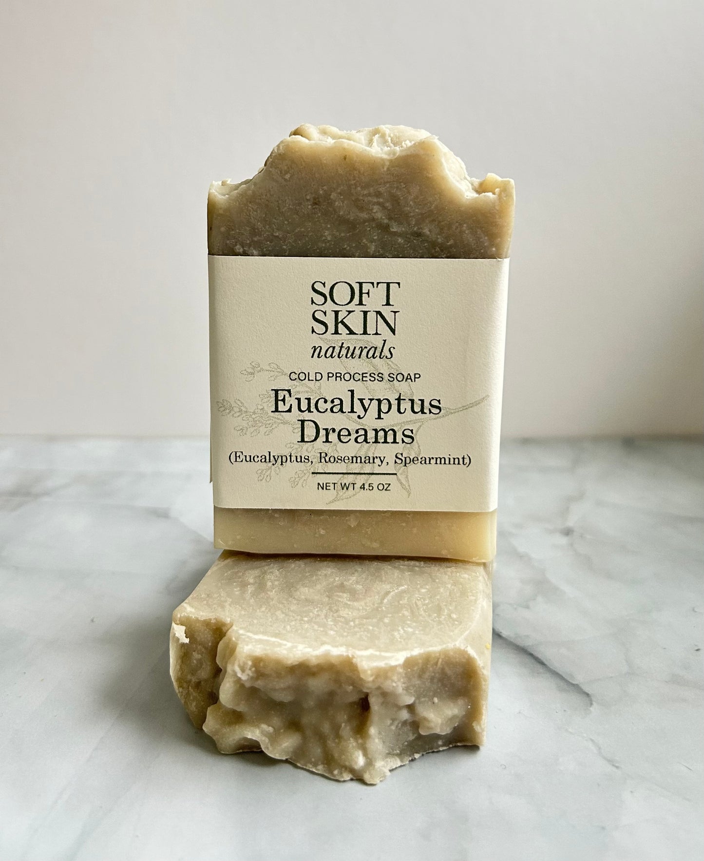 Bar of soap with a label on a marble surface
