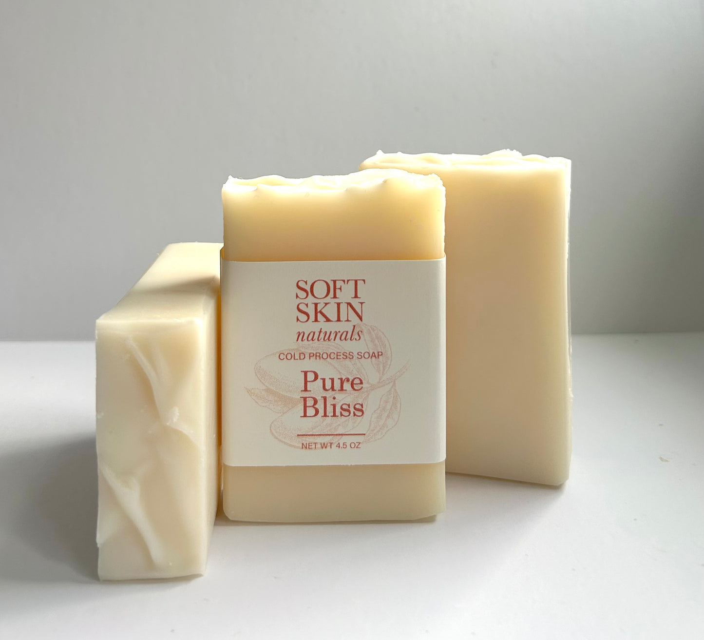 Three bars of Soft Skin Naturals Pure Bliss soap on a white background