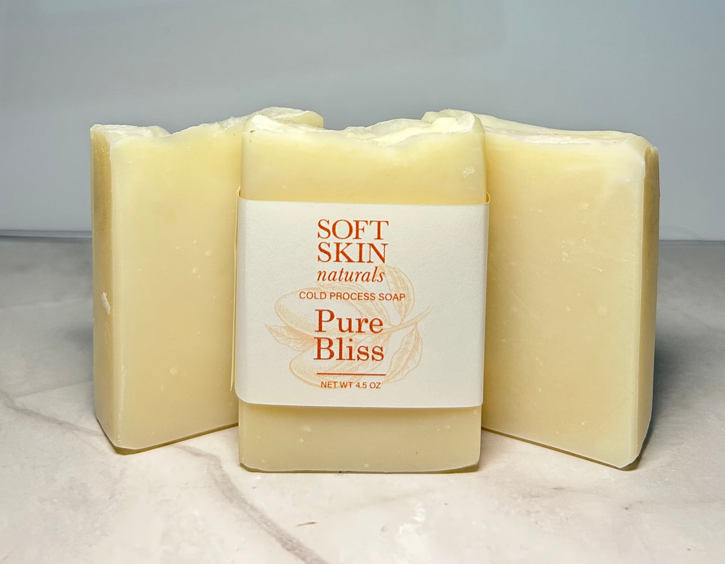 Three bars of Soft Skin Naturals Pure Bliss soap on a light background