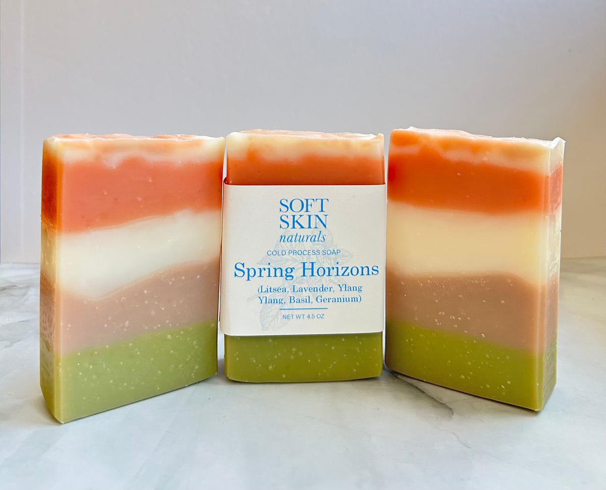 Three layered soap bars with a packaging label in the center on a white background