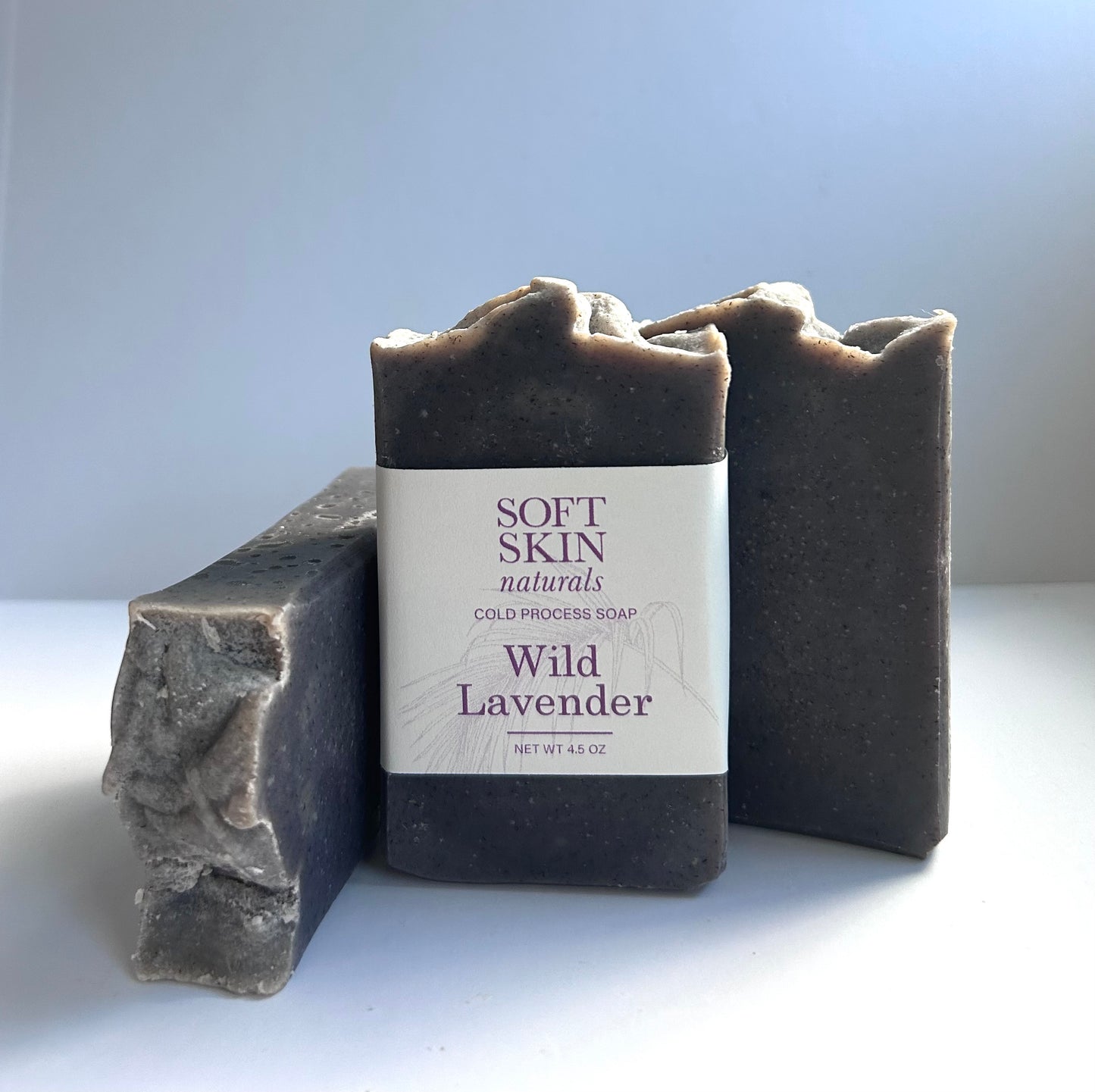 Three bars of Wild Lavender soap from Soft Skin Naturals on a white background