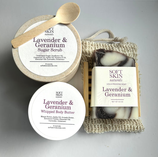 Soft Skin lavender and geranium products including scrub, soap, and body butter on a gray background