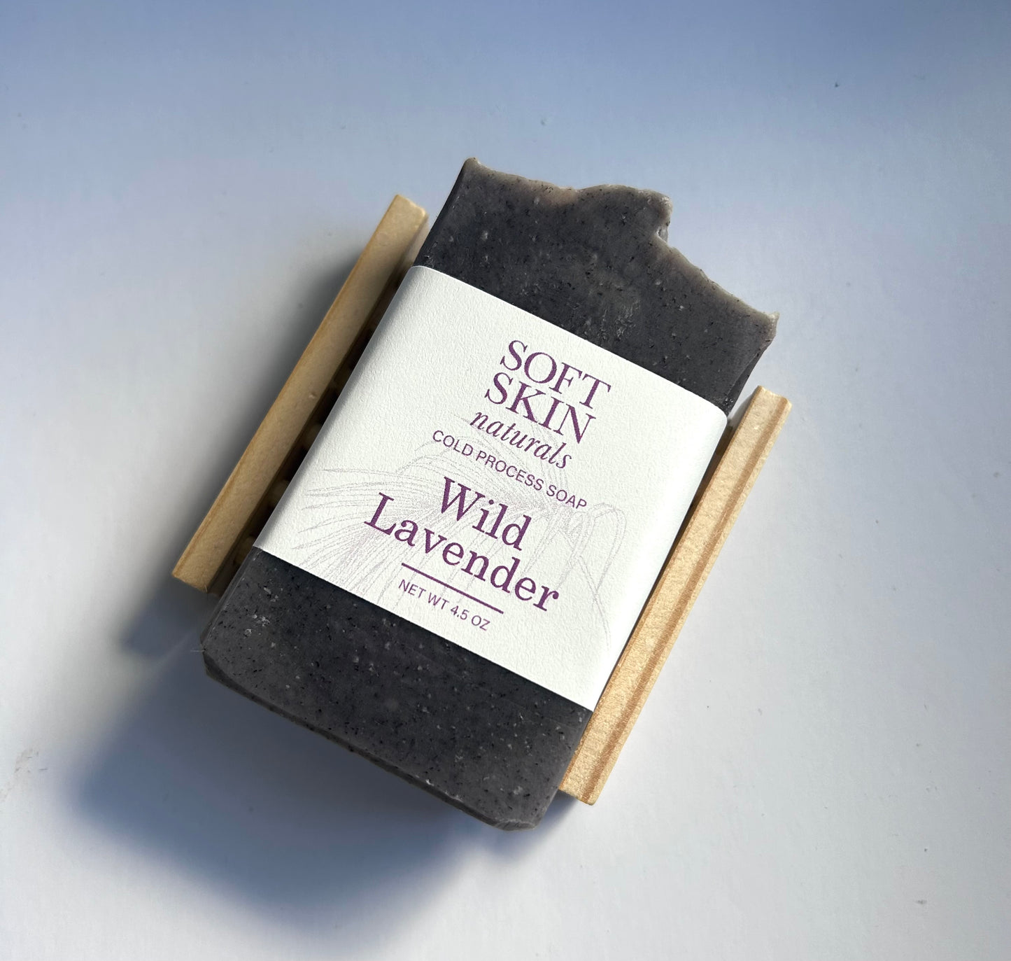 Bar of wild lavender soap with a visible label on a light gray background