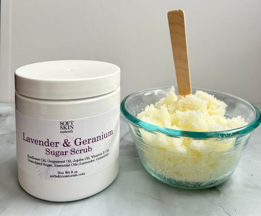 Lavender & Geranium Sugar Scrub container with a bowl of scrub on a light background