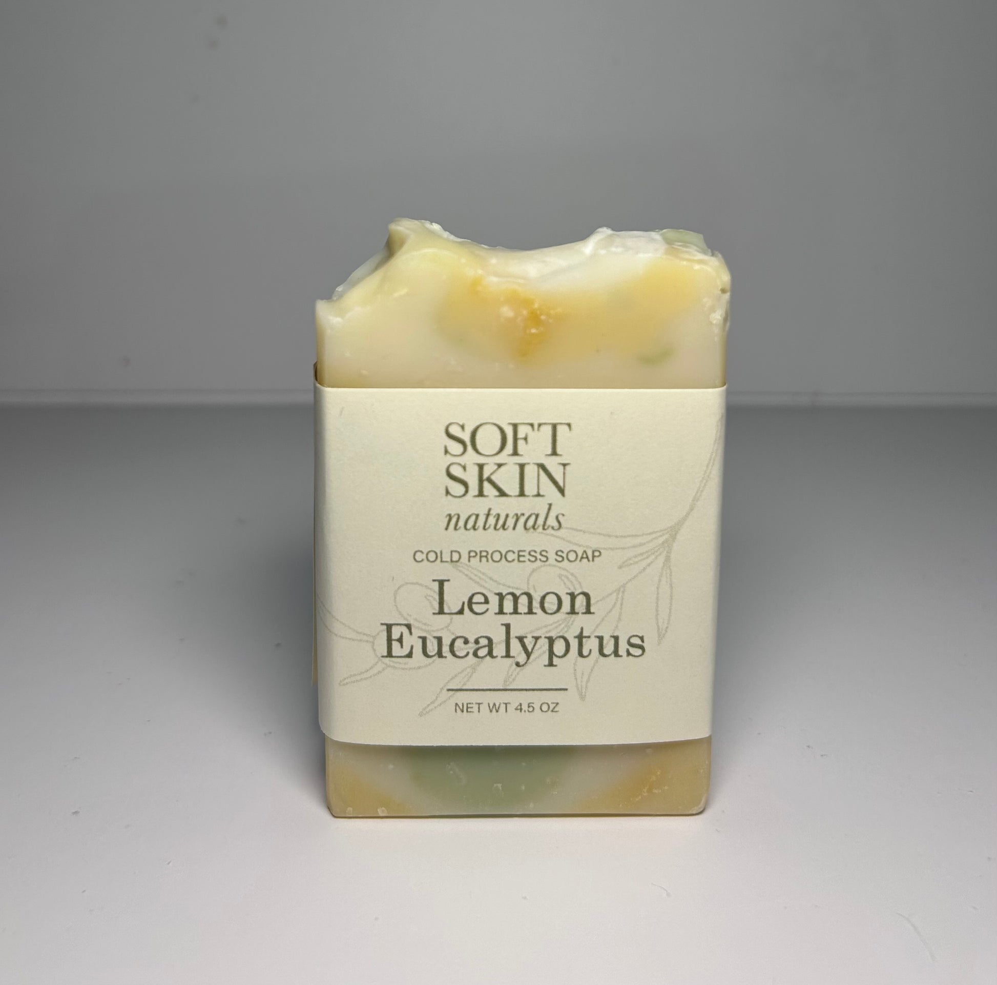 Bar of soap labeled Soft Skin Naturals Lemon Eucalyptus on a gray background