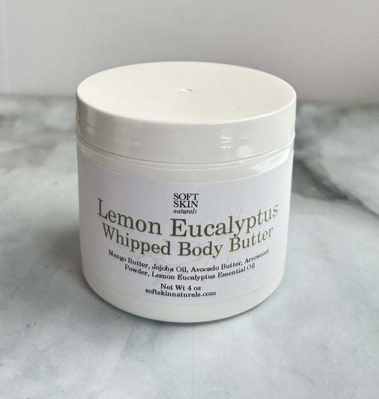 White jar of Lemon Eucalyptus Whipped Body Butter on a gray surface