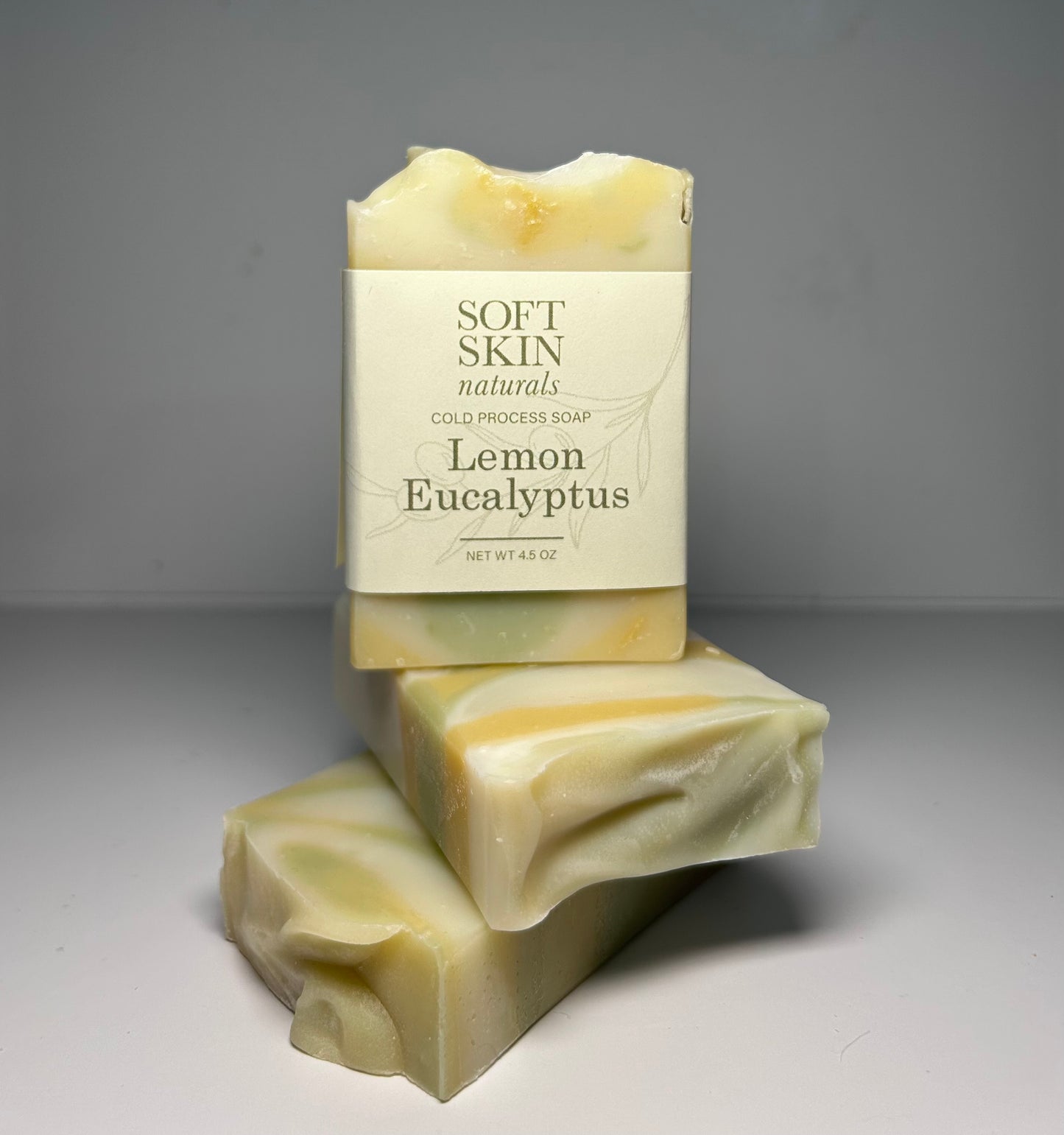Two bars of soap with a Soft Skin Naturals label on a gray background