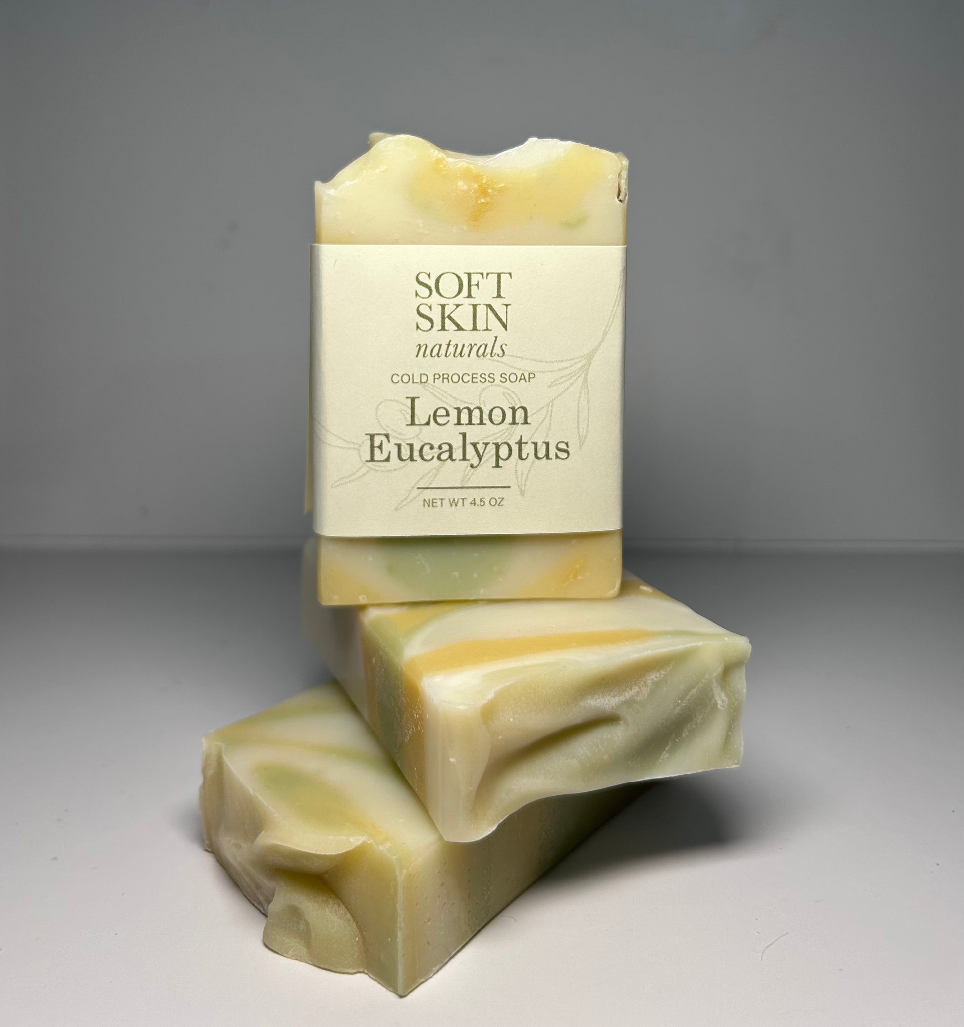 Two bars of soap with a Soft Skin Naturals label on a gray background
