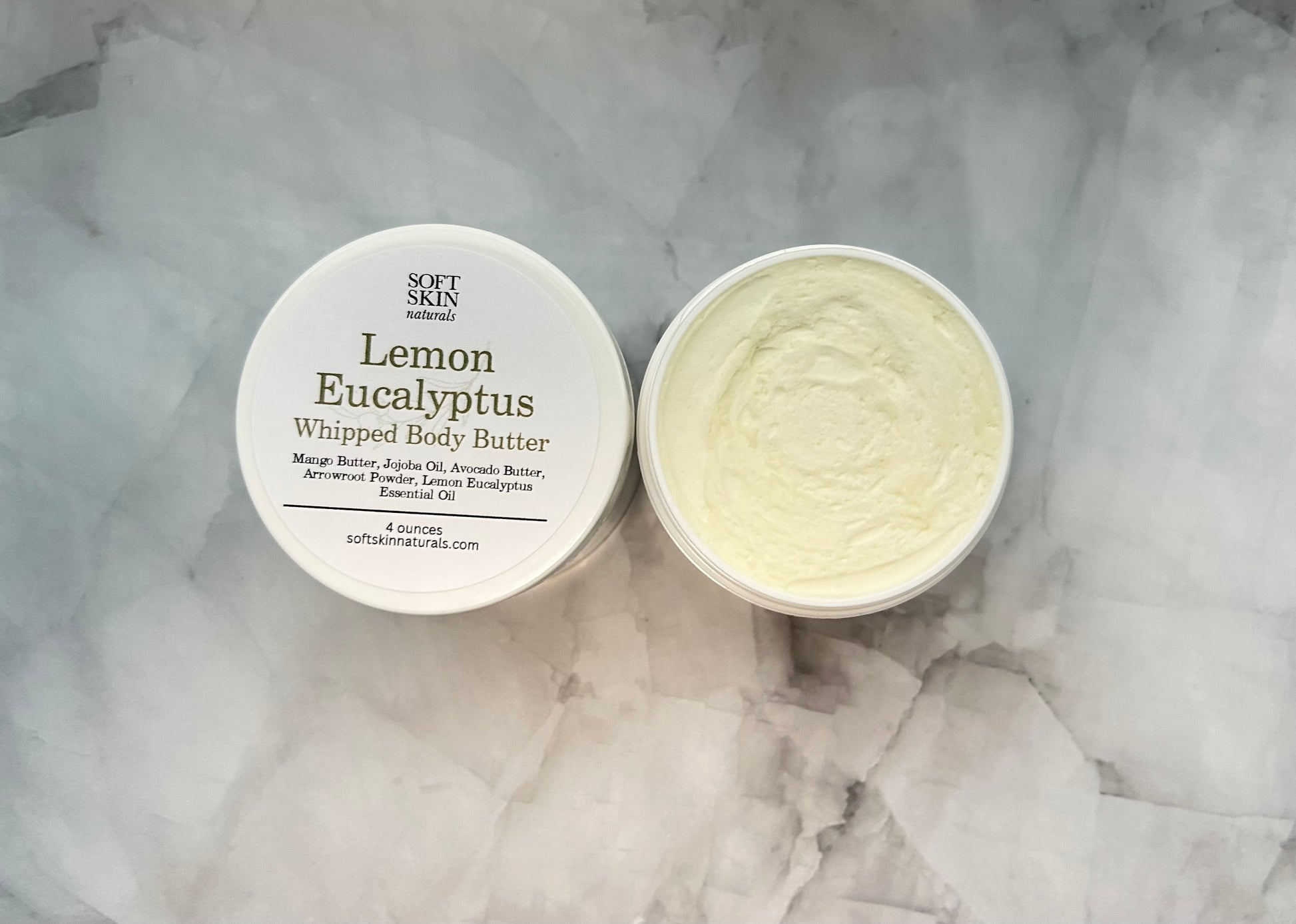Two containers of Lemon Eucalyptus whipped body butter on a marble surface