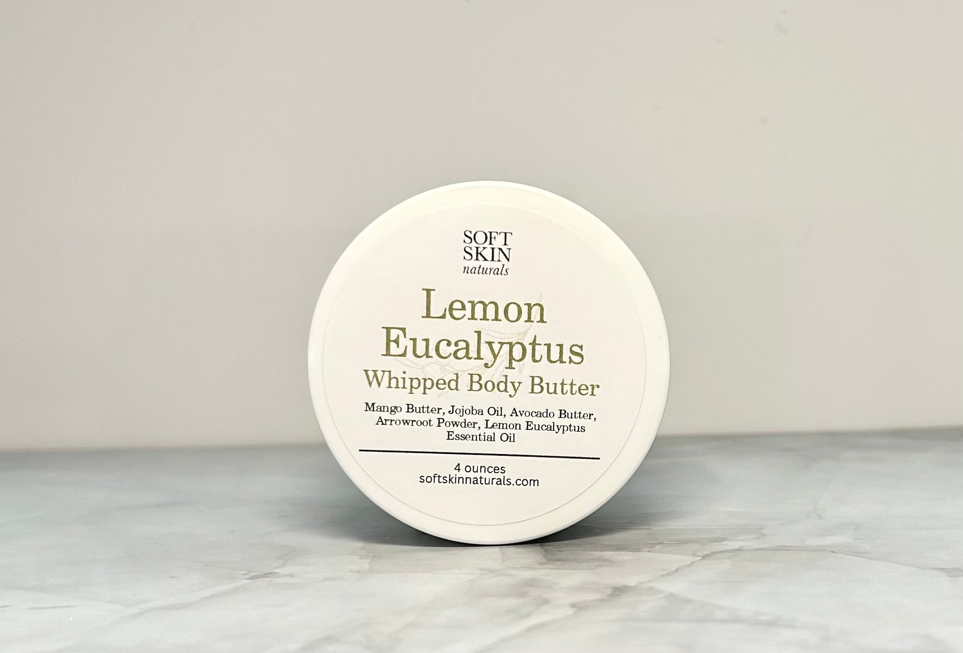 Container of Lemon Eucalyptus whipped body butter on a light gray background