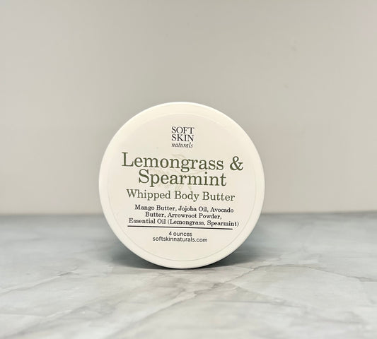 Round container of Soft Skin Naturals Lemongrass & Spearmint Whipped Body Butter on a marble surface.