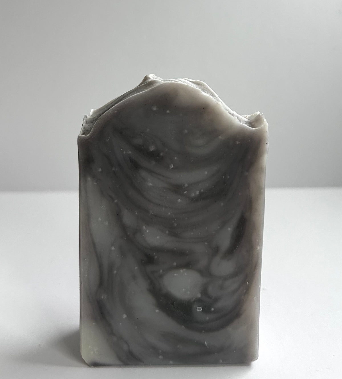 Marble-patterned soap bar on a light gray background