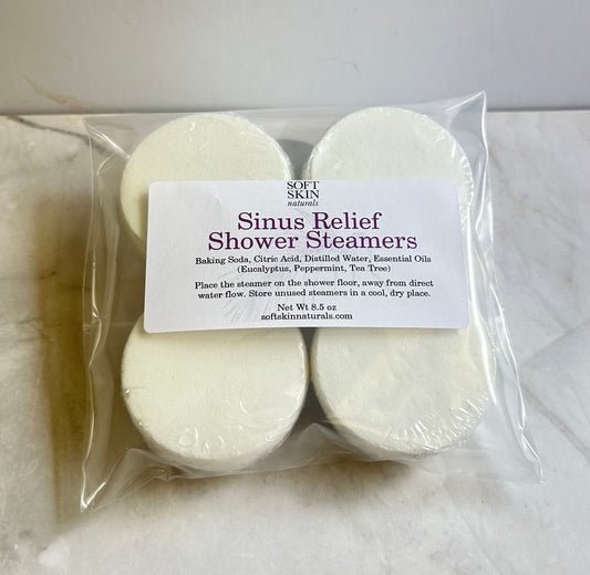 A clear plastic bag containing four round white sinus relief steamers.