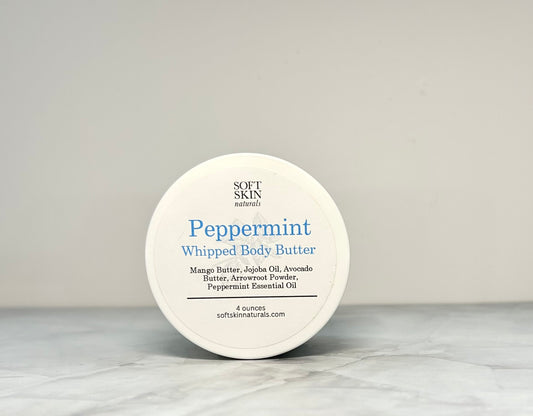 Jar of peppermint whipped body butter sitting on a table