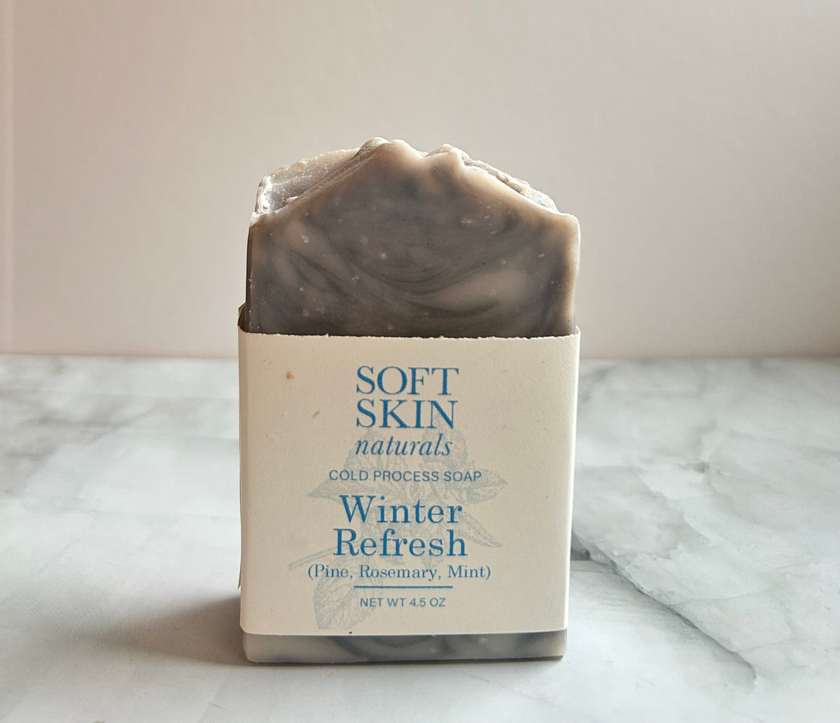 Bar of soap with a label on a marble surface