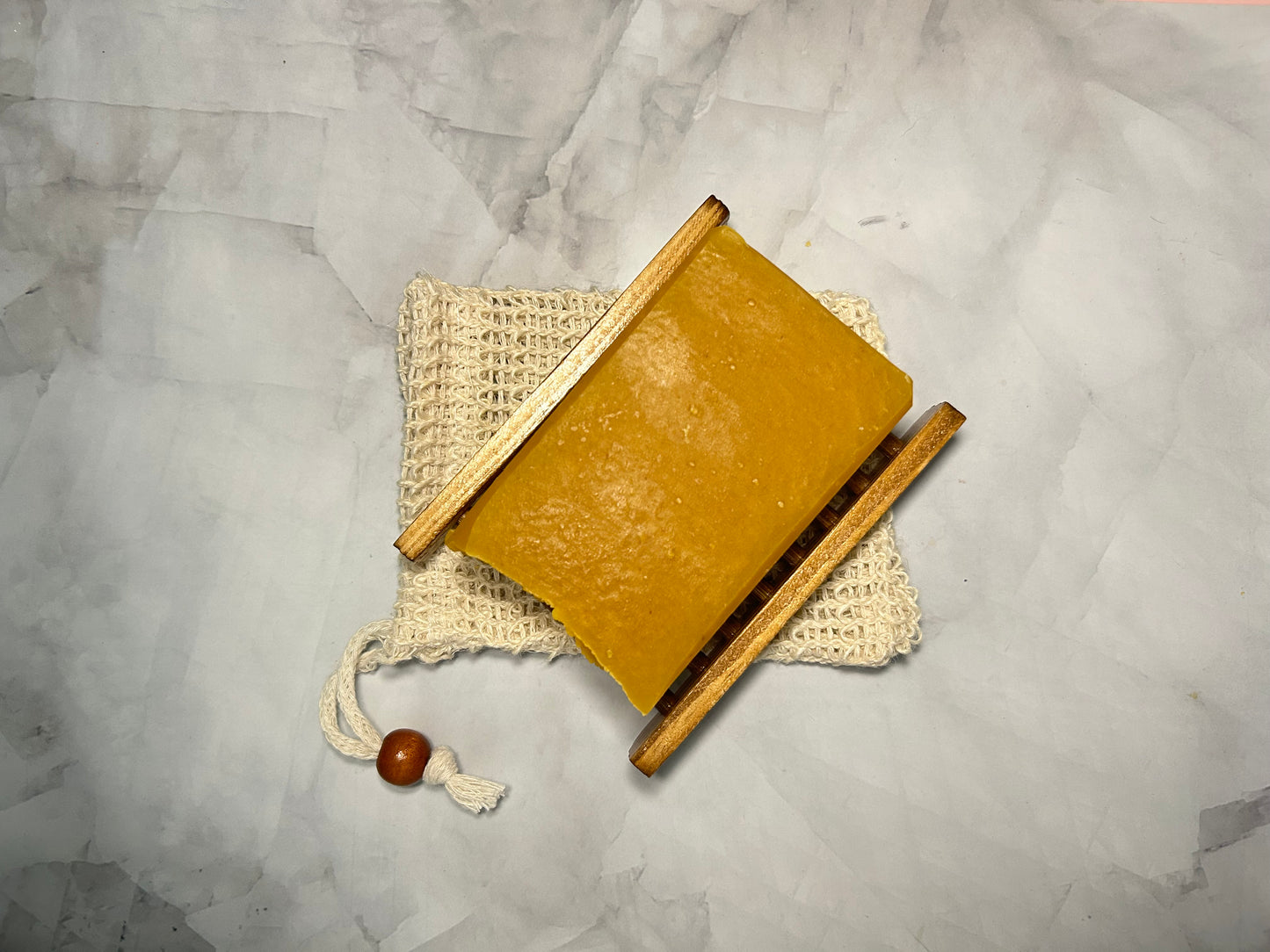 Brown soap with wooden accents on a textured gray surface