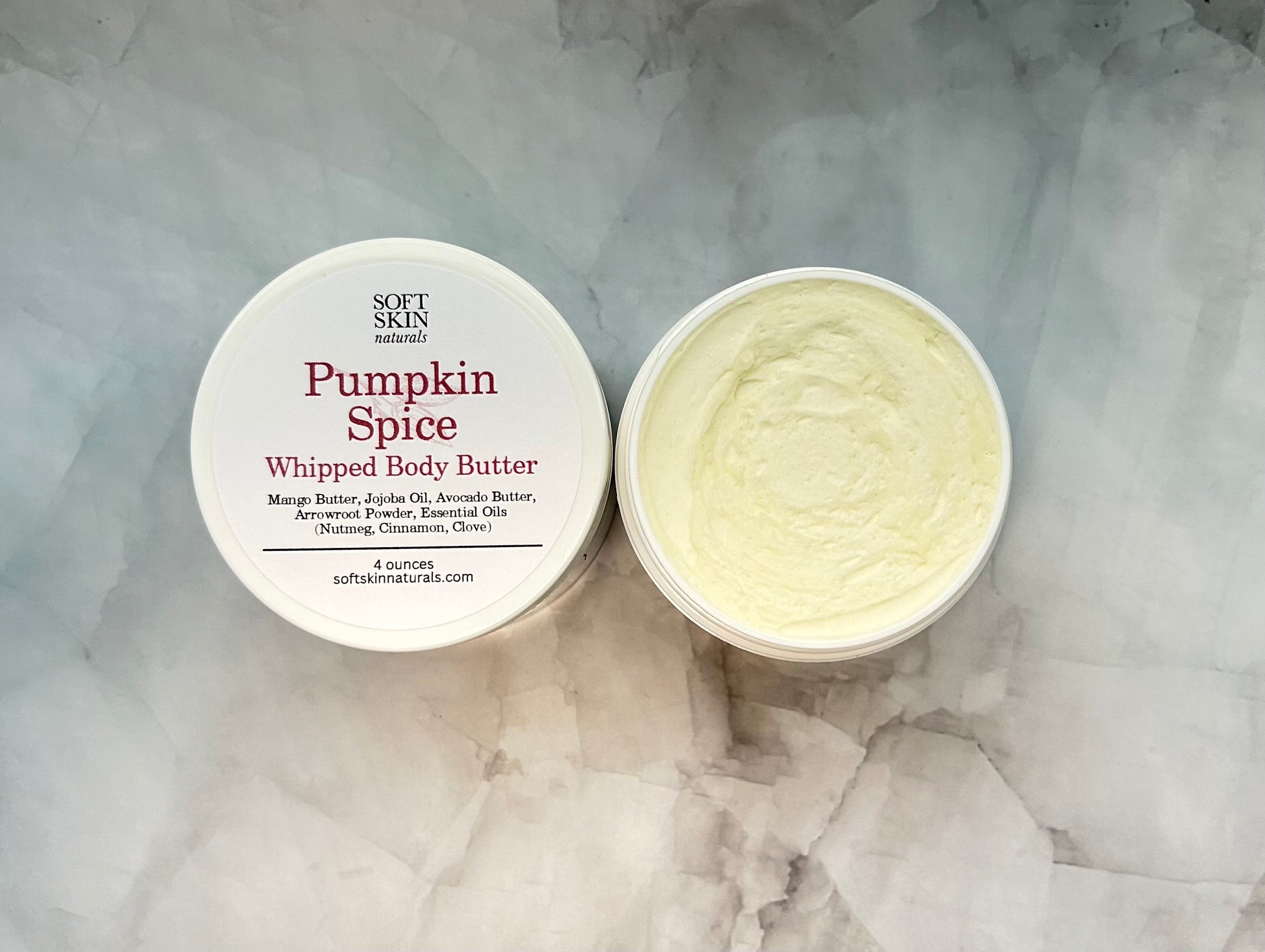 Pumpkin Spice whipped body butter with a container on a marble surface