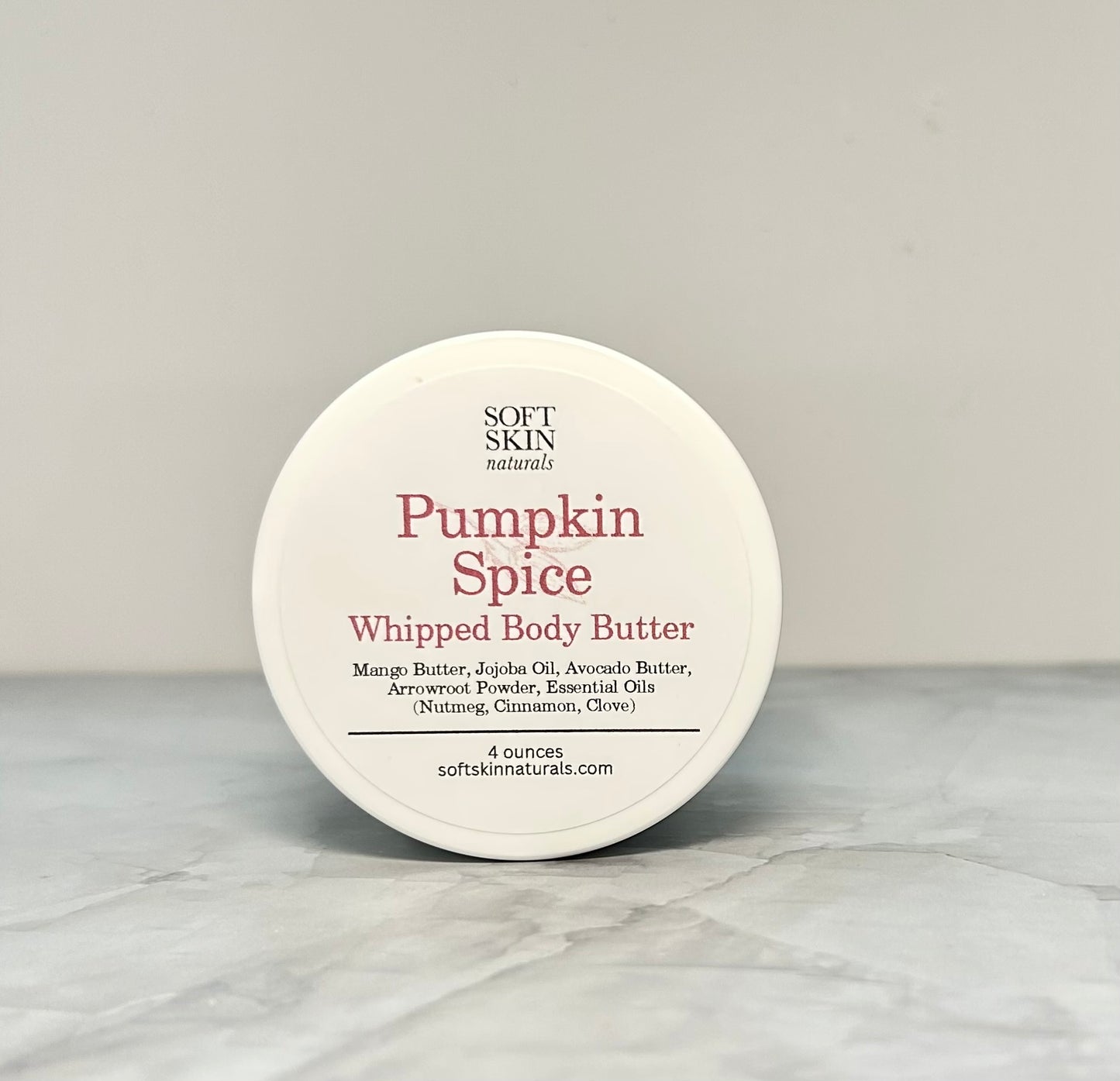 Pumpkin Spice whipped body butter container on a gray background