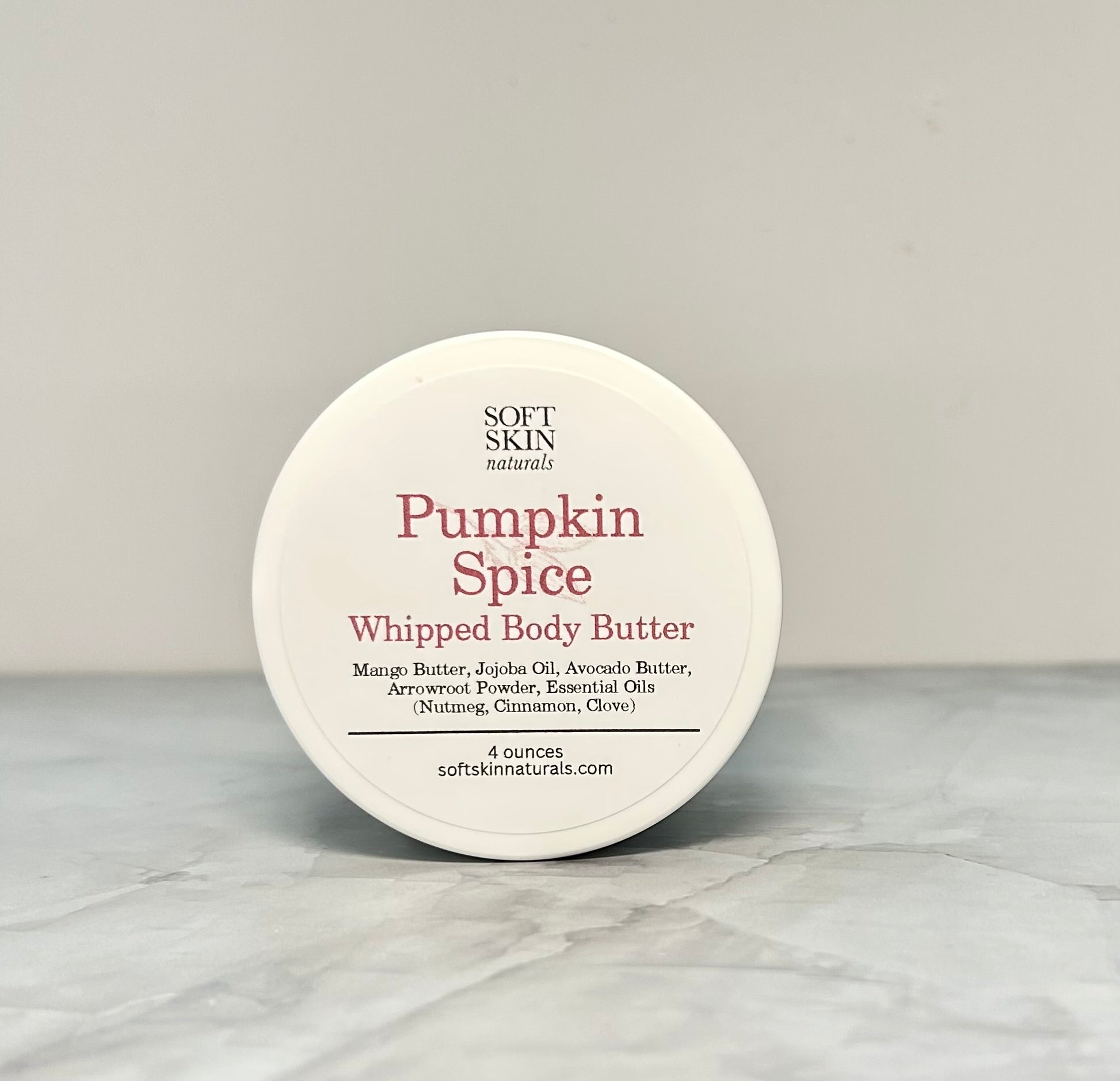 Pumpkin Spice whipped body butter container on a gray background