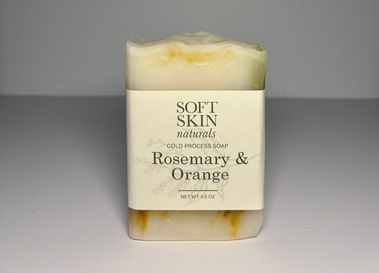 Bar of soap with Soft Skin Naturals label on a gray background