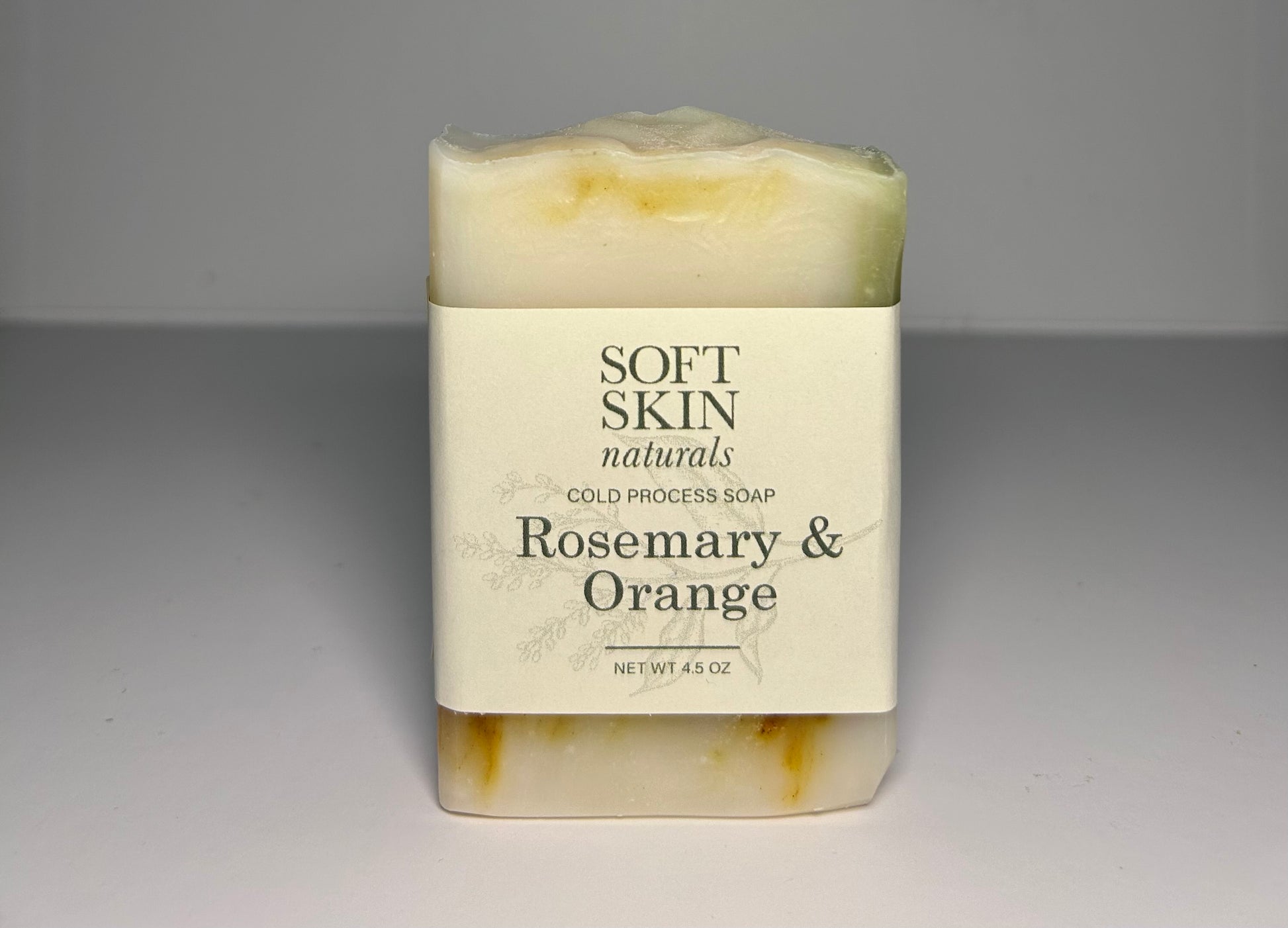 Bar of soap with Soft Skin Naturals label on a gray background