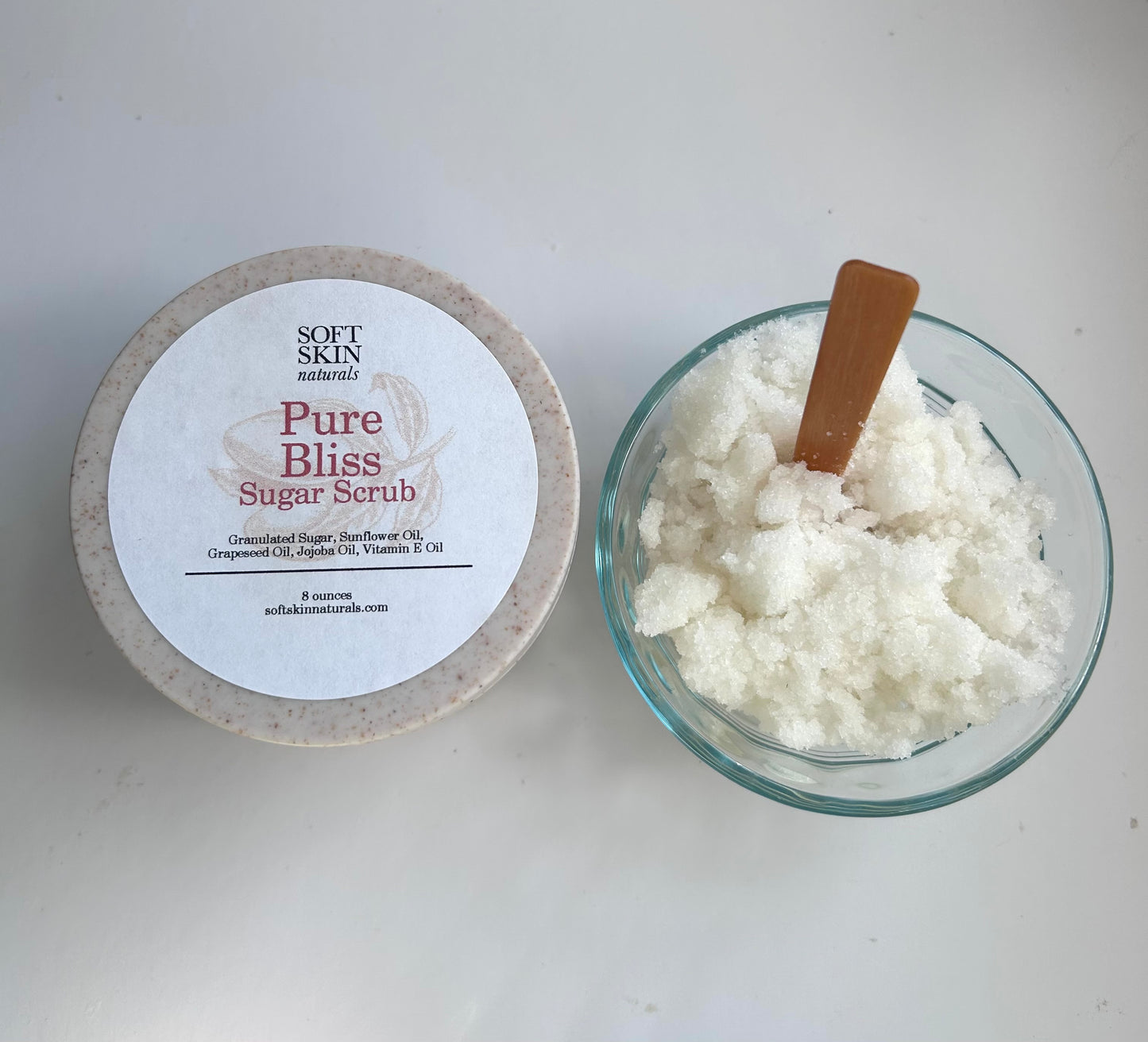 jar of sugar scrub on a gray background