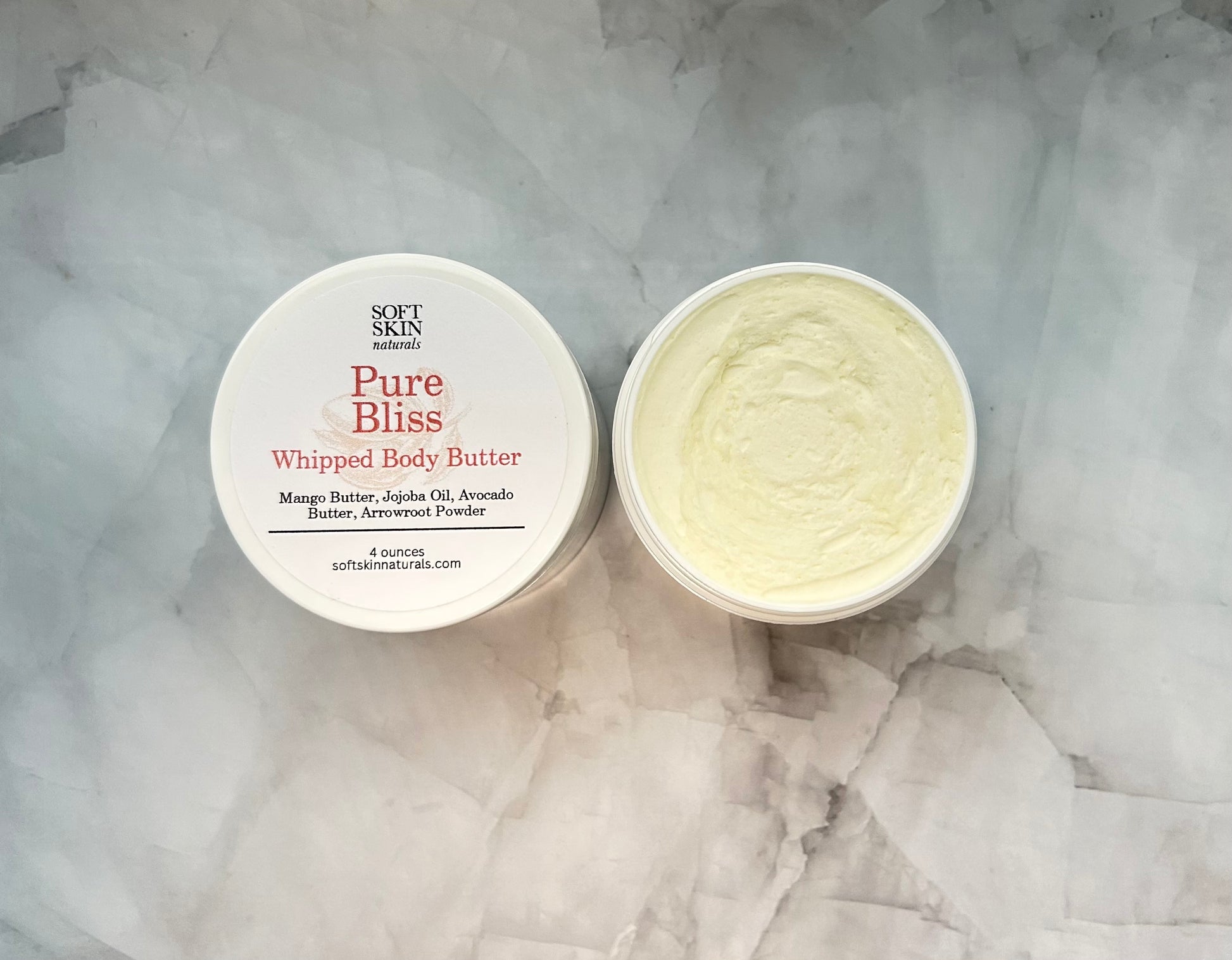 Pure Bliss Whipped Body Butter container on a marble surface