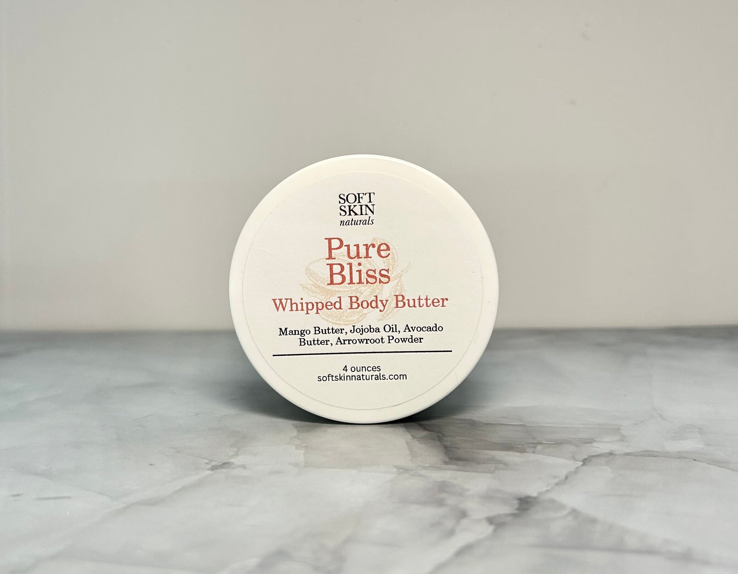 Jar of fragrance free whipped body butter sitting on a table. 