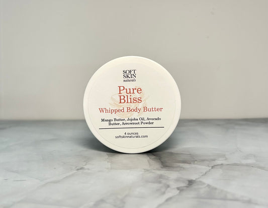 Jar of fragrance free whipped body butter sitting on a table. 