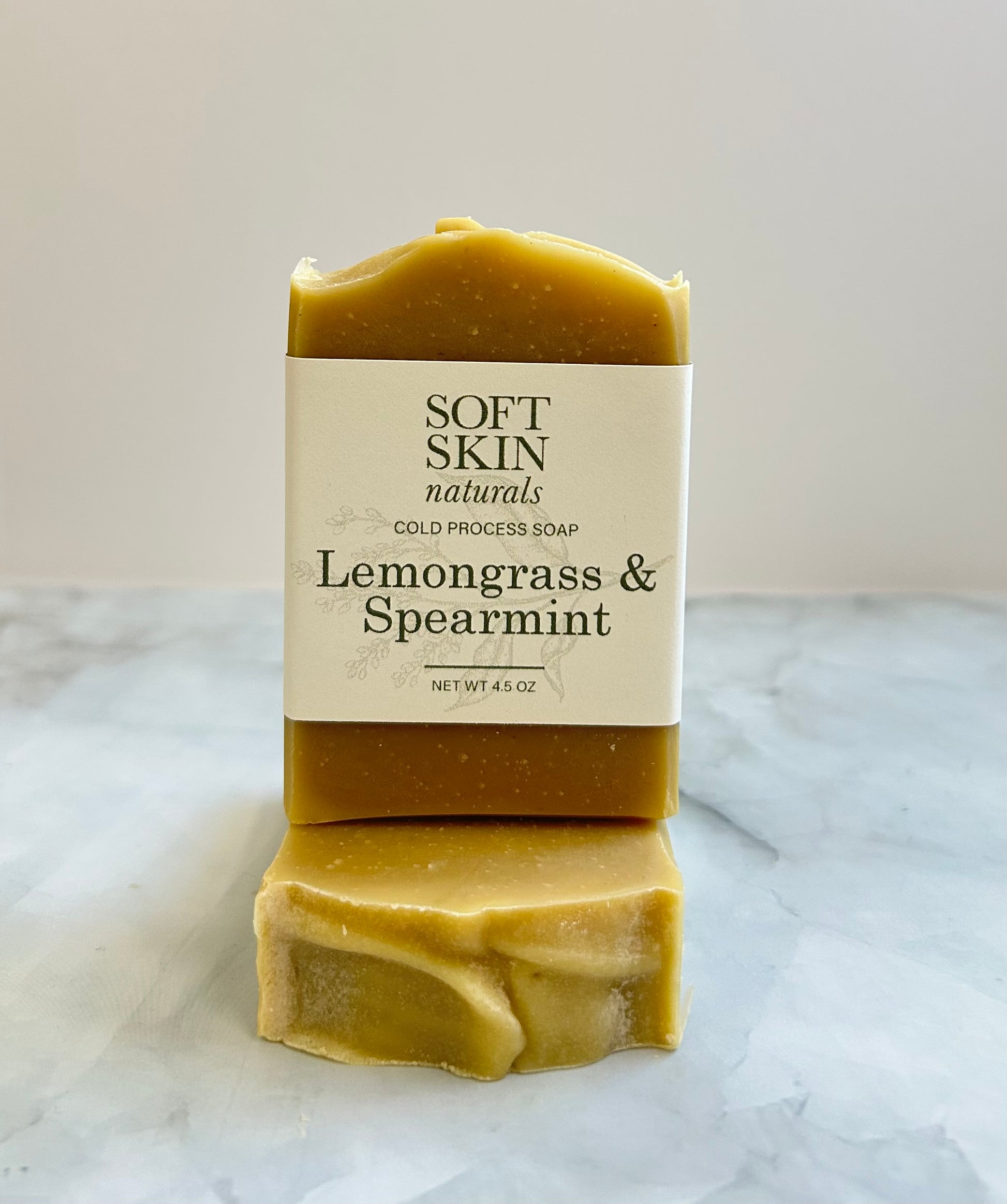 Bar of soap with 'Soft Skin Naturals' label on a marble surface