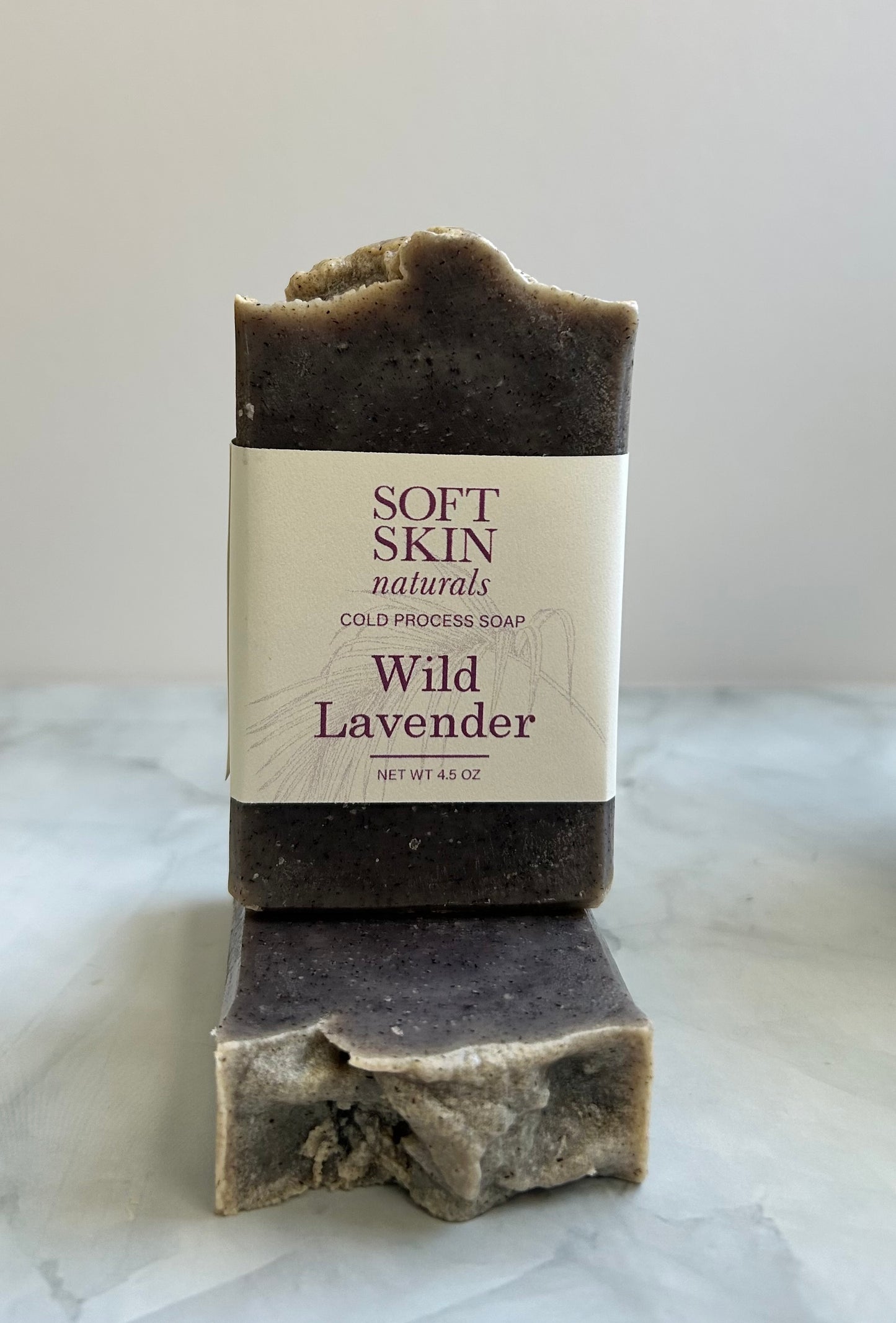 Bar of soap with a label on a marble surface