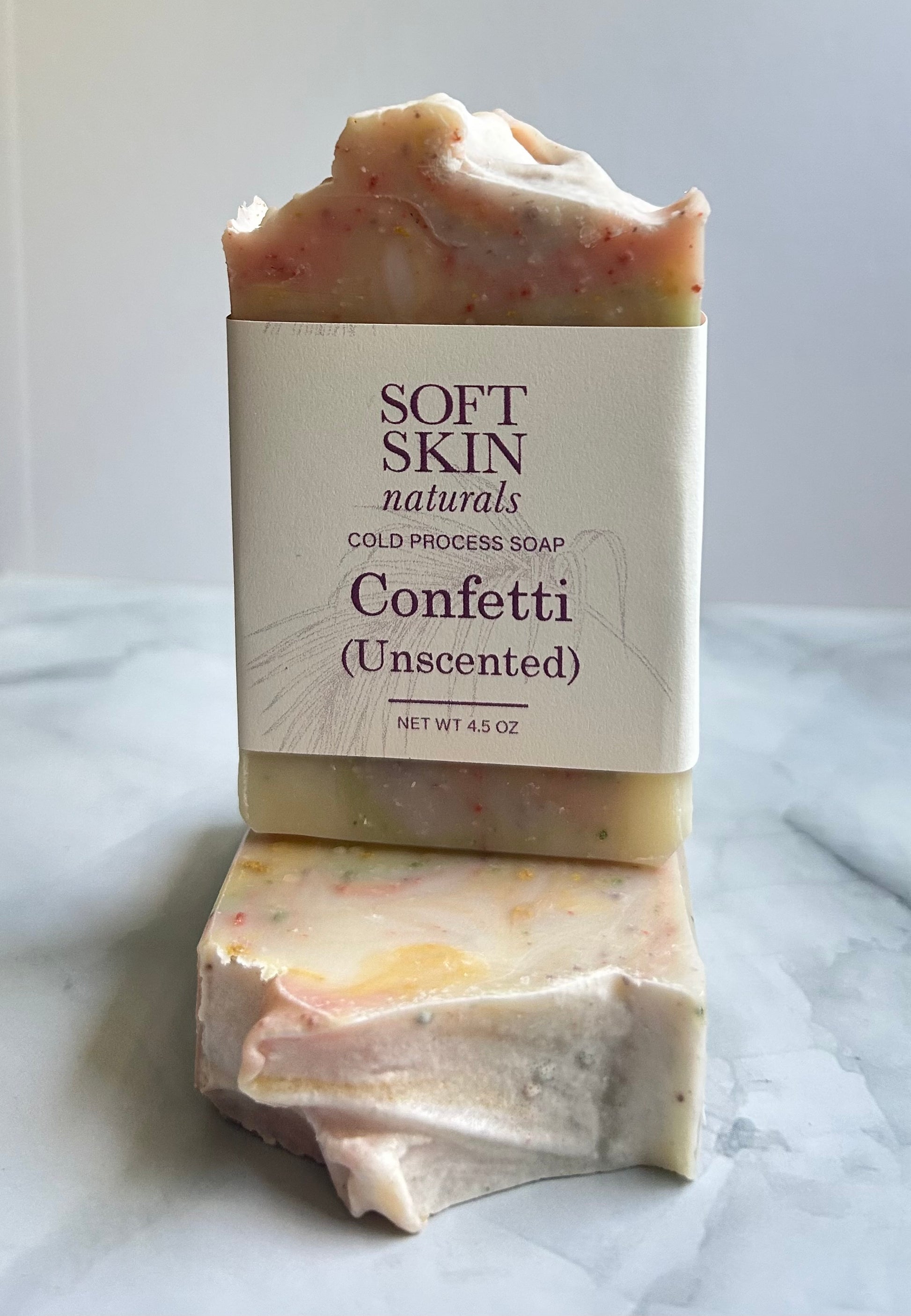 Multi-colord soap sitting on top of two other soaps