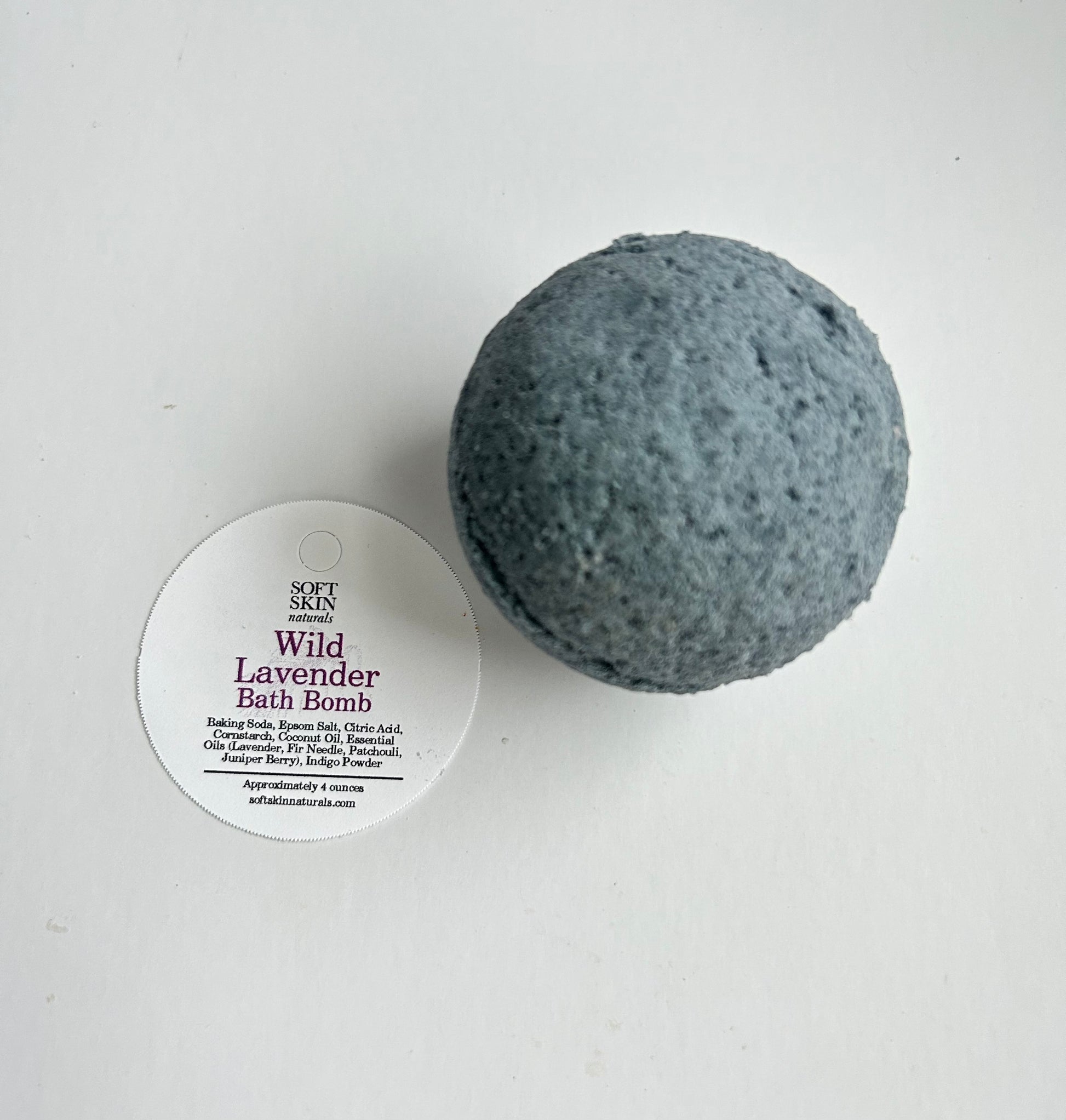 Blue bath bomb with a label on a white background