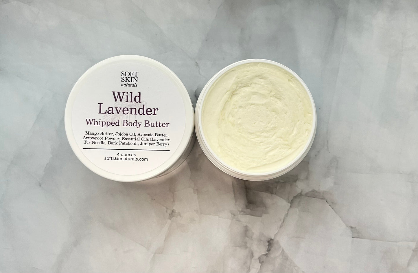 Wild Lavender whipped body butter with a white container on a marble surface